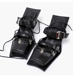 Pair of black leather anklets with silver buckles on a white background